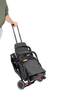 Black stroller being pushed on a white background